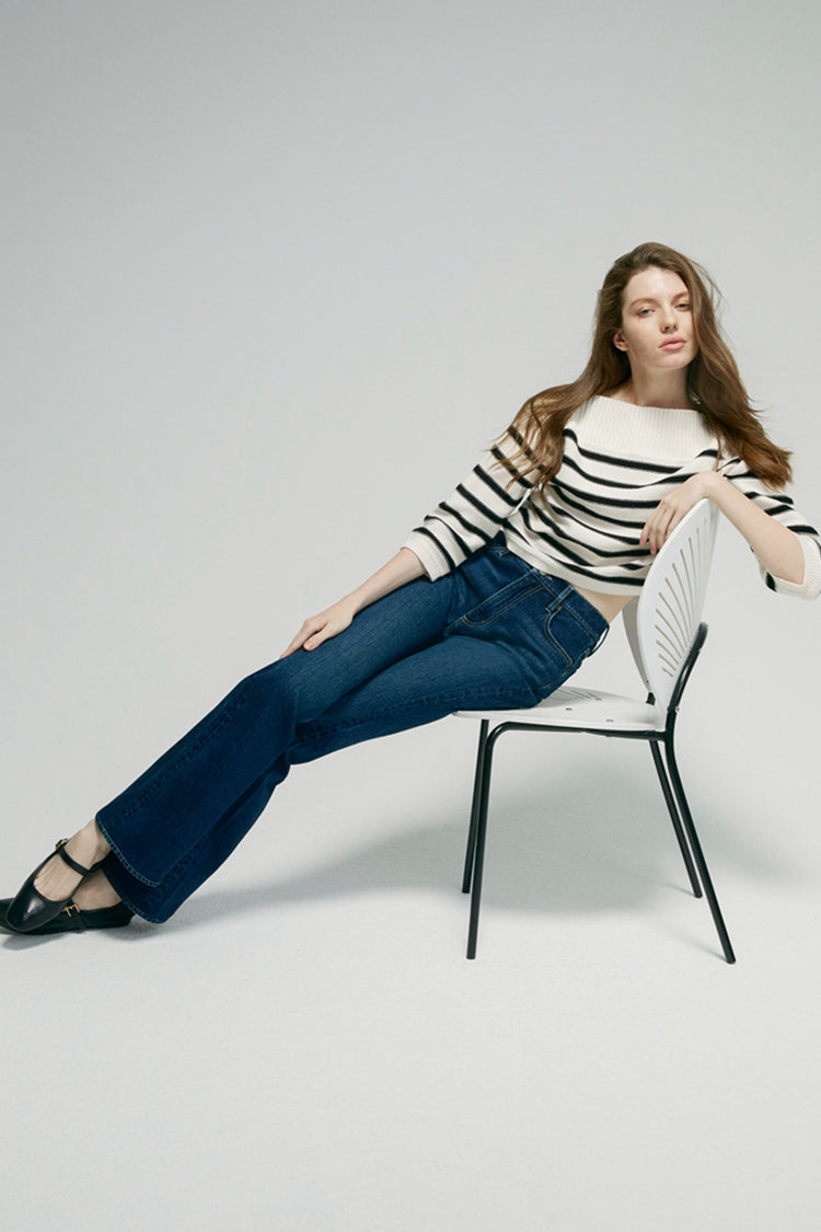 Hey Joanie Barbara high rise bootcut jeans in denim, showing the fit and flare of the stylish jeans with a focus on the details.