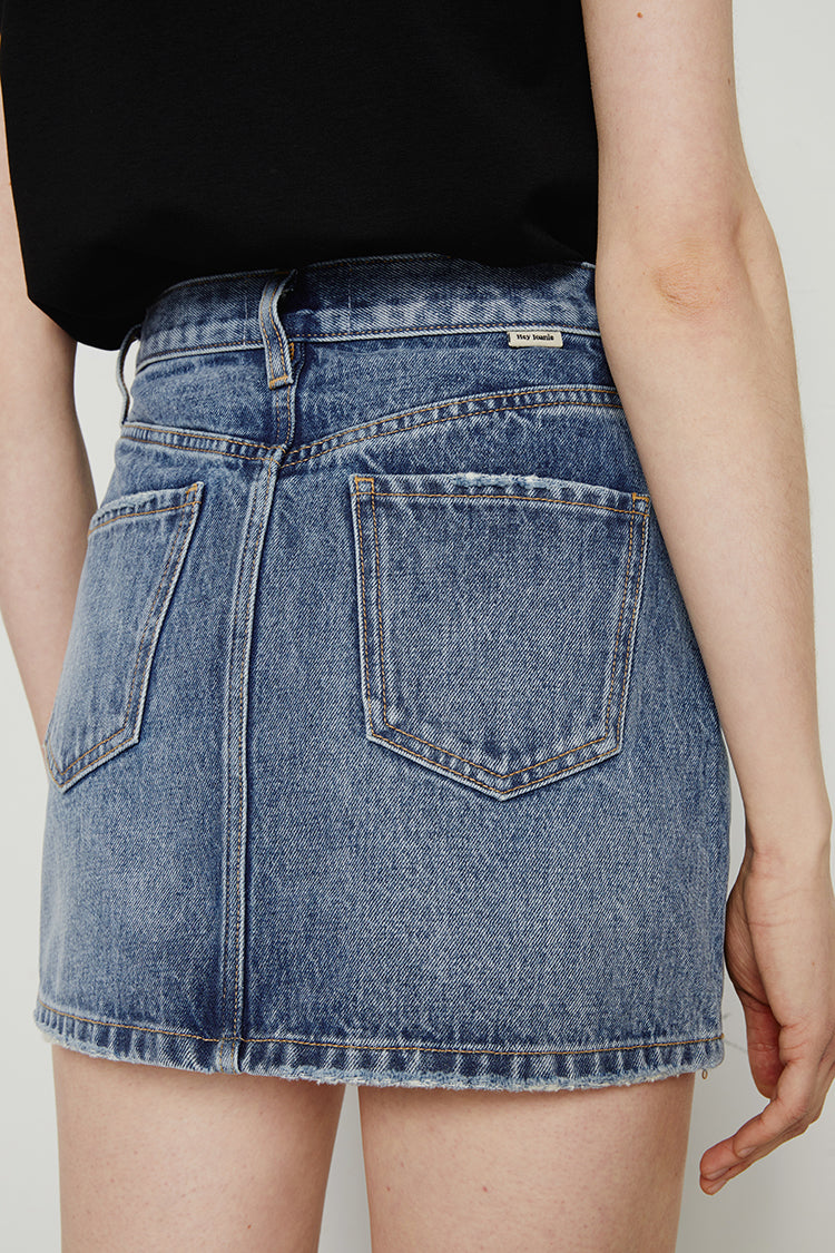 Vintage 80s Hey Joanie mini skirt in black with a high waist and button front detail, styled for a retro look.