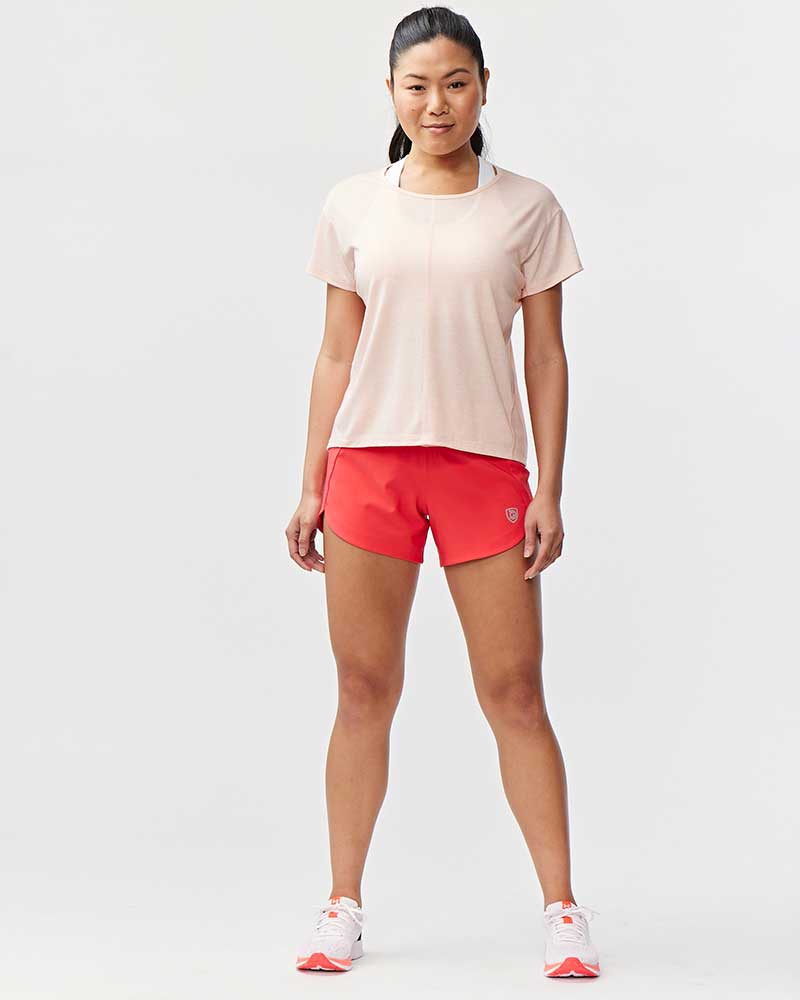 Excel women's training workout shorts in hot coral nectar color, designed for comfortable exercise and activewear.
