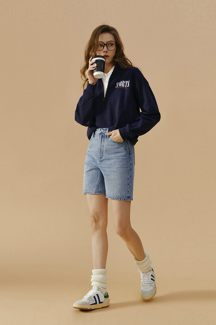 Hey Joanie Angeles High Rise Shorts in denim, featuring a fitted waist and rolled hem, displayed on a neutral background.