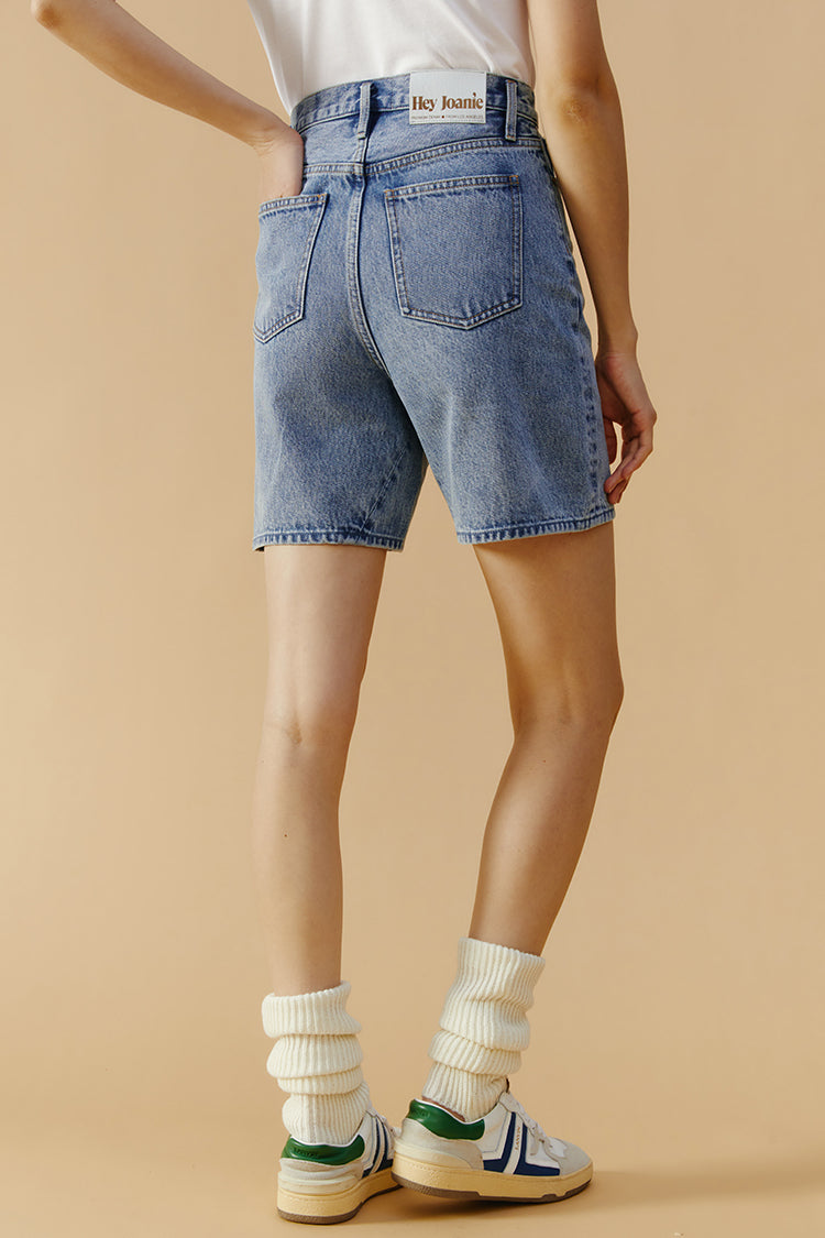 Hey Joanie Angeles high-rise denim shorts with frayed edges and distressed details, front view on white background.