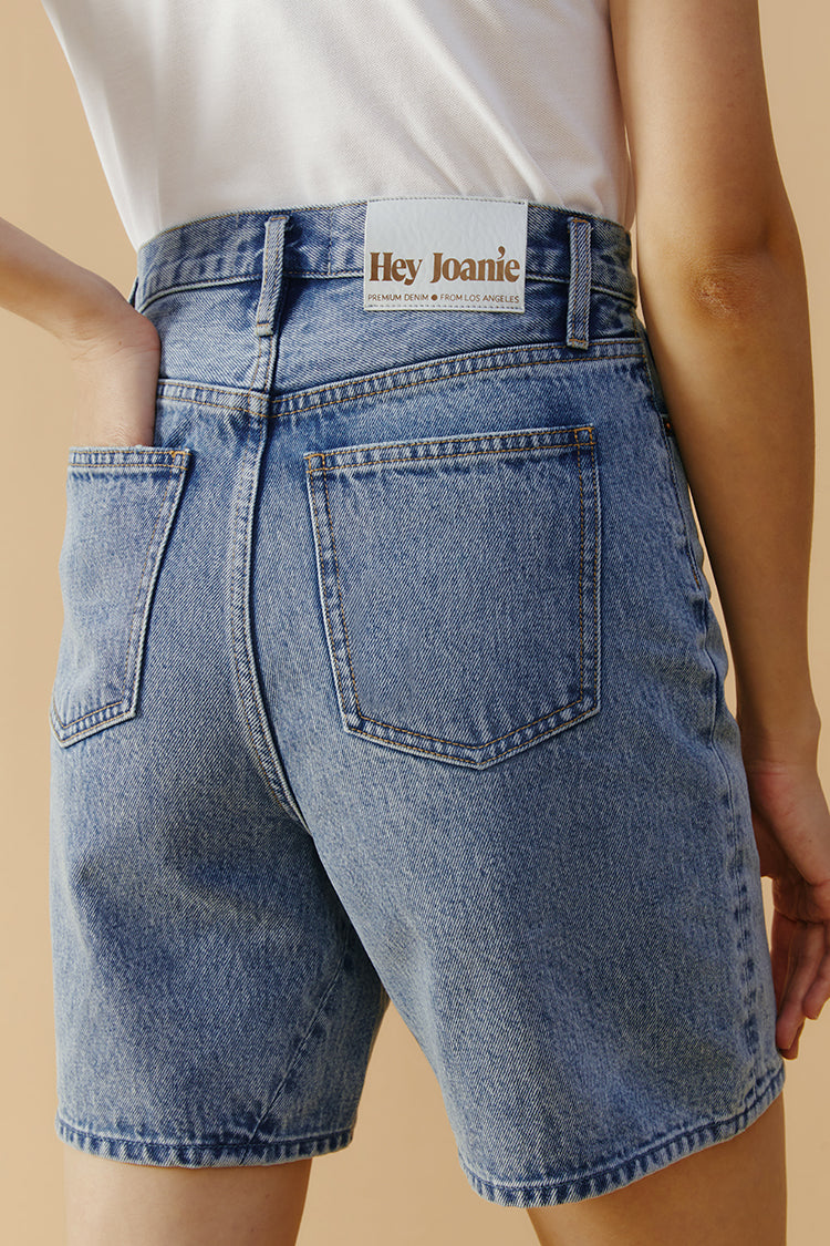 Hey Joanie Angeles high-rise shorts in denim, featuring a fitted design and classic five-pocket style, displayed on a neutral background.