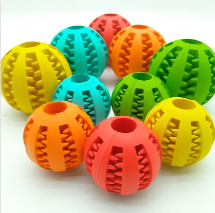 Interactive rubber slow feeder dog ball by C&M Treasures, featuring a textured surface and hollow design for engaging play and feeding.